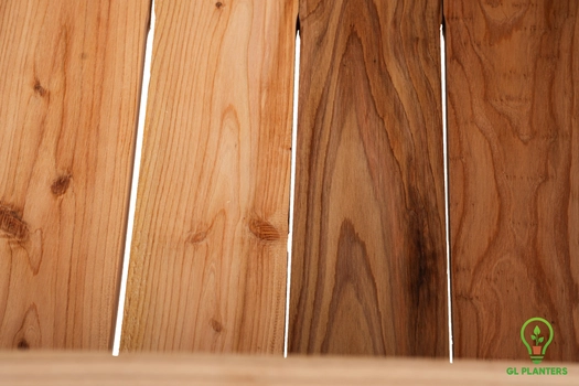 Underside of cedar planter showing precision-slotted base for natural drainage.