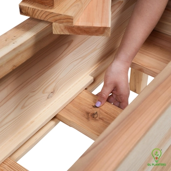 Grooved cedar base supporting soil weight and drainage in elevated planter box